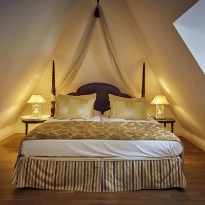 Large comfy bed in Rosengarten Suite at Falkensteiner Hotels