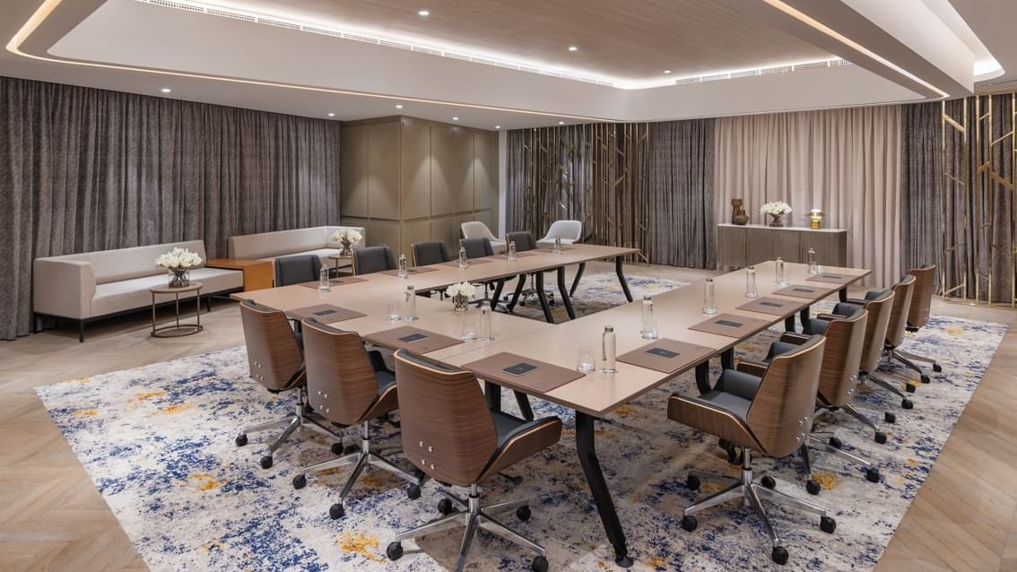 Modern Studio 3+4 at Paramount Hotel Midtown with elegant decor, a large table, ergonomic chairs, and floral arrangements