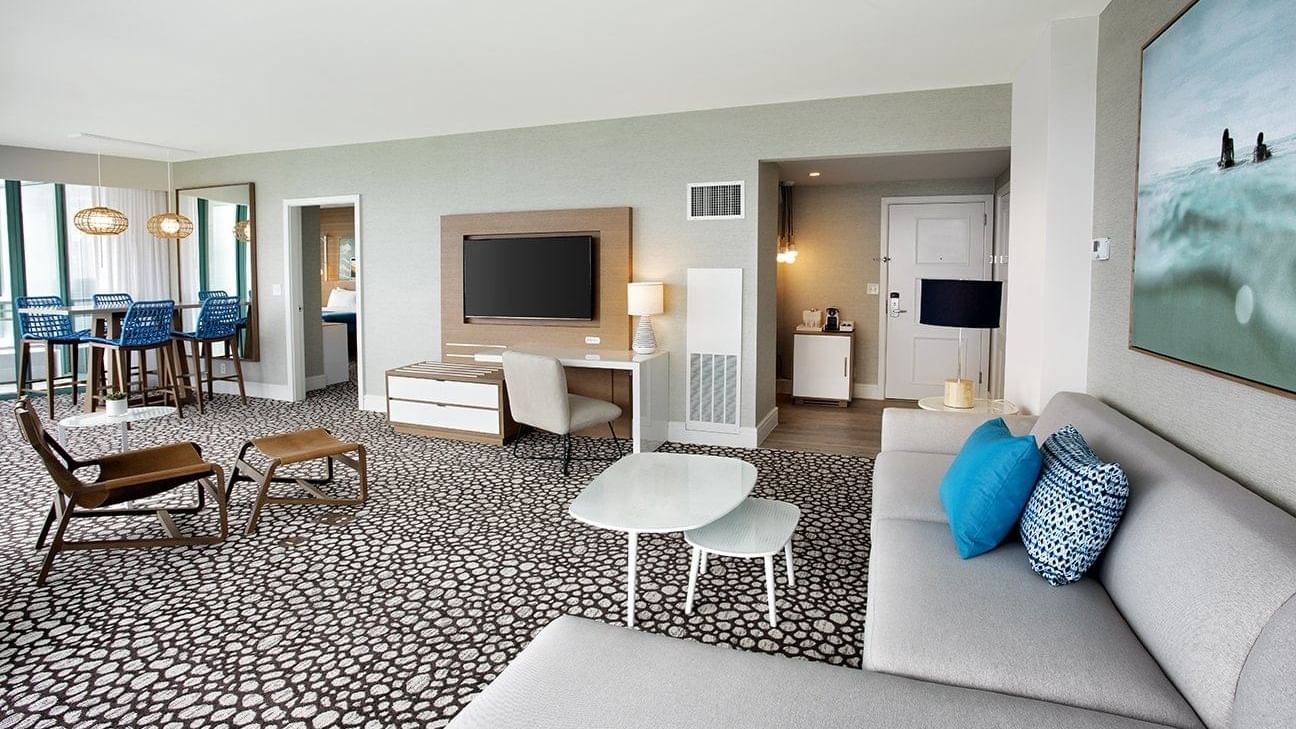 Living area with TV & dining table set-up in Corner Suite at The Diplomat Resort