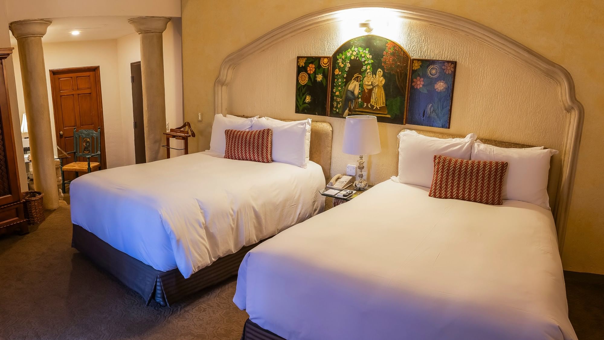 Grand Class room with two double beds, decorative artwork, and arched alcove at Quinta Real Zacatecas