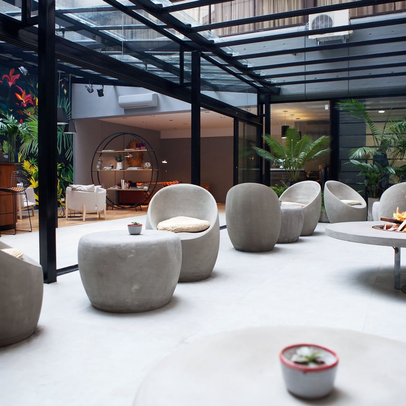 An Open air Lounge area by a fireplace at DecO Recoleta Hotel