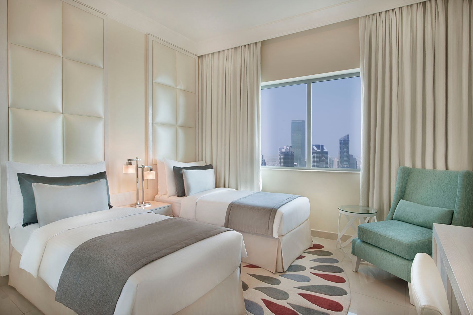 Two beds and city view in Three Bedroom Suite, one of the hotel rooms in Dubai at DAMAC Maison Mall Street
