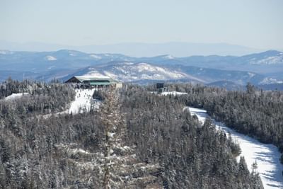 Snow-covered Gore Mountain with ski slopes and lodge in The Lodge in Schroon Lake
