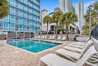 Sun beds arranged by the outdoor swimming pool at The Yachtsman Resort
