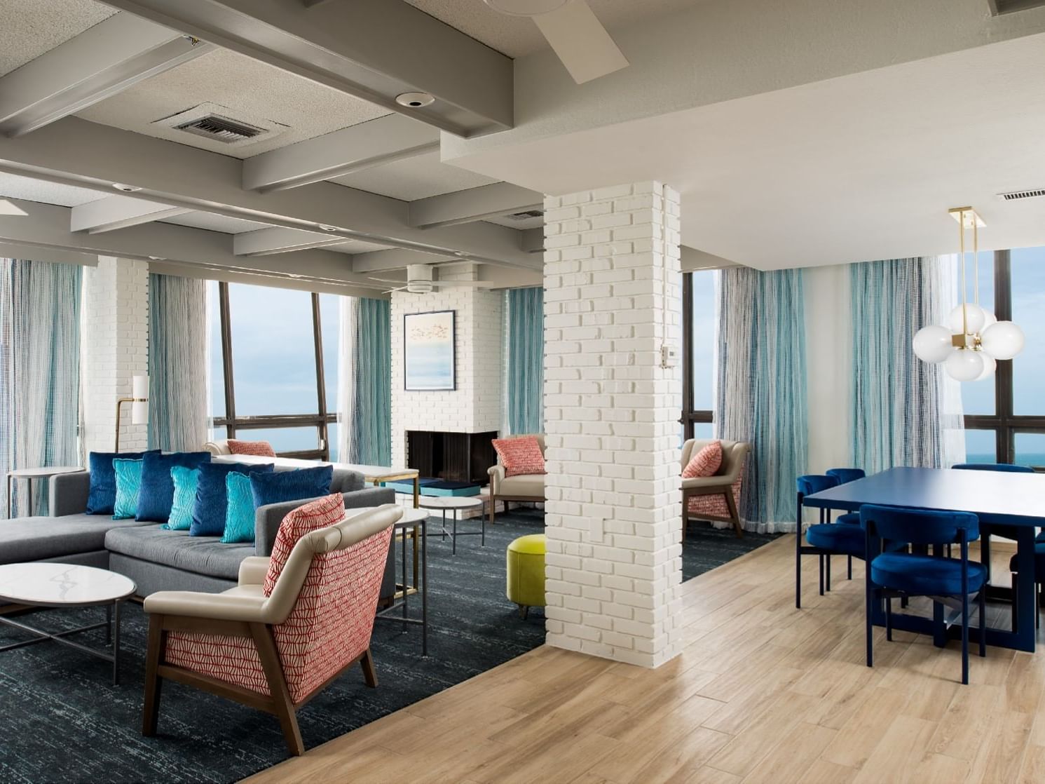 Dining area by living area with carpeted floors in Medjool Palm Penthouse at Bilmar Beach Resort