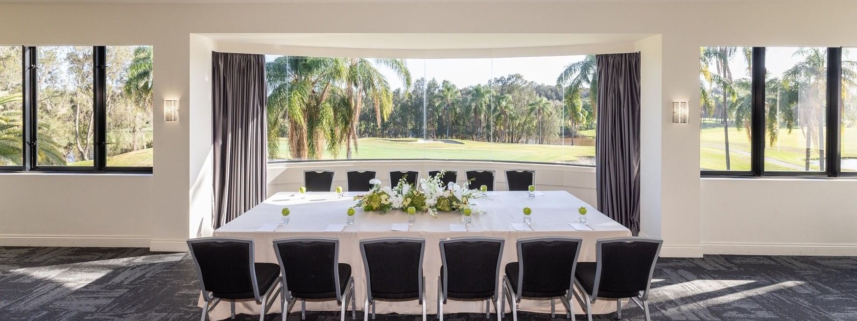 Elegantly set dining table with flowers at Mercure Gold Coast Resort in Carrara.