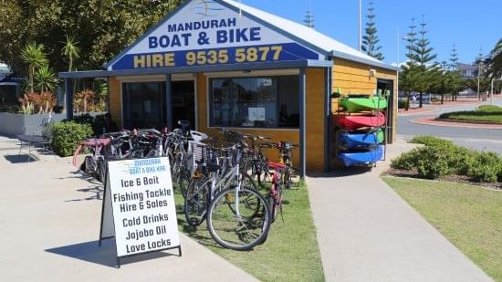 Small shop for Mandurah Boat & Bike Hire with bikes displayed outside on a sunny day near The Sebel Mandurah