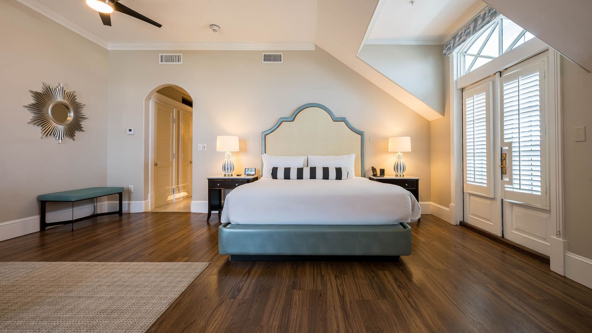 Spacious suite with hardwood floors and a king bed at The Pearl Hotel in Rosemary Beach.