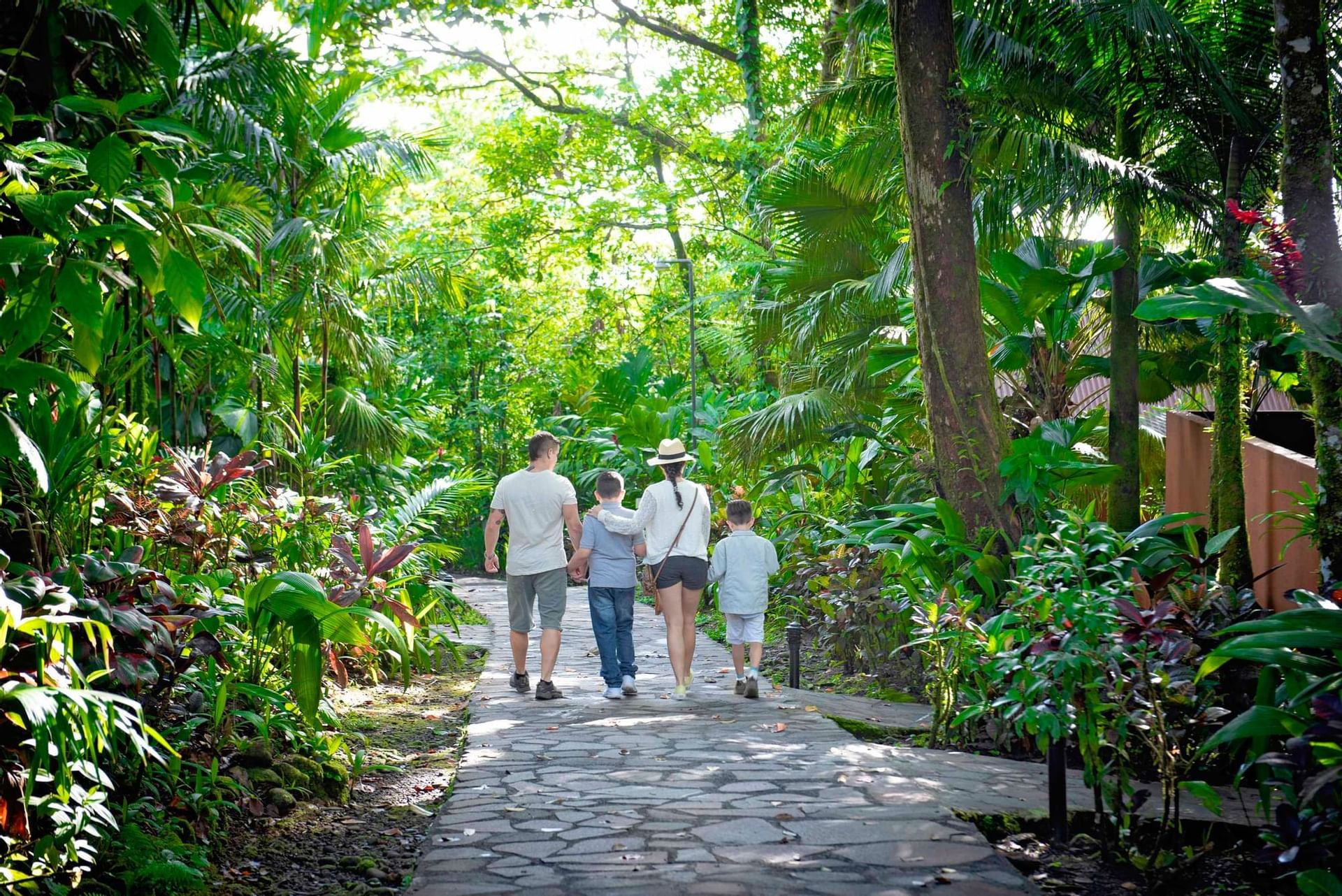 Family walking through the hotel garden at Rio Celeste Hideaway
