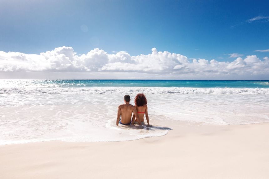 A couple enjoying the beach view near Bougainvillea Barbados