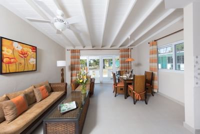 Living and dining area with modern furniture and large windows in Deluxe Suite at All Seasons Resort Europa