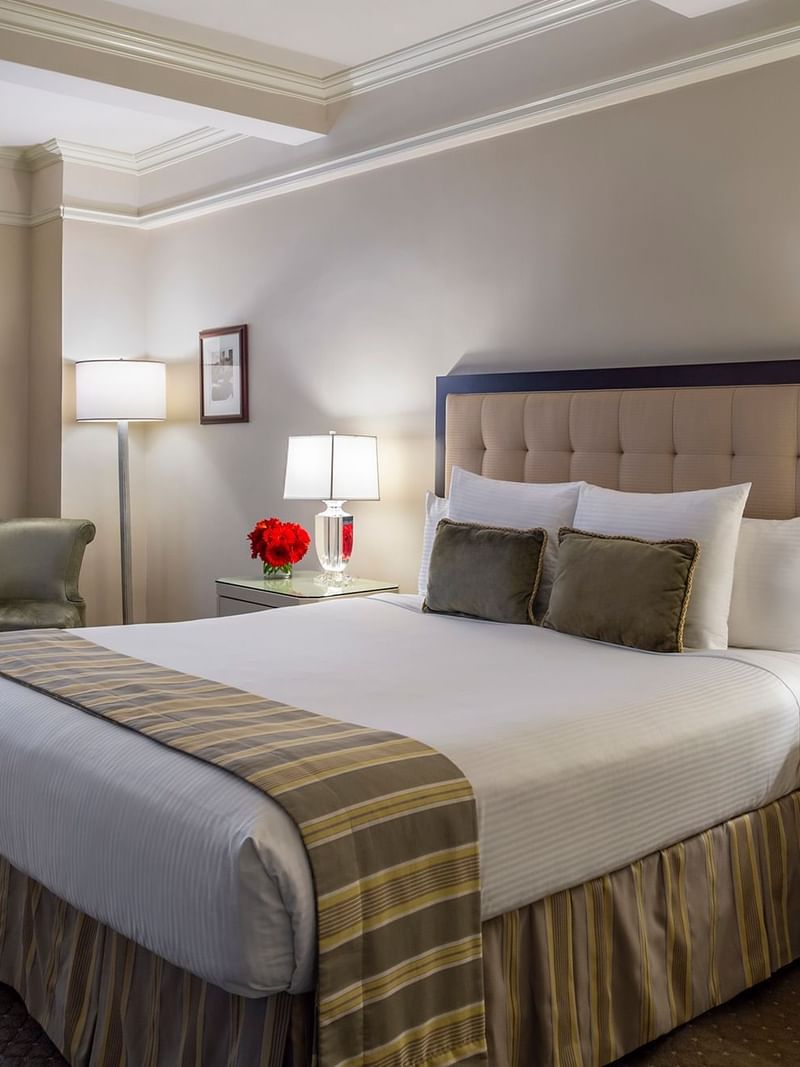 Push king bed between side lamps with beside chair in Accessible Premier City View at Warwick New York 