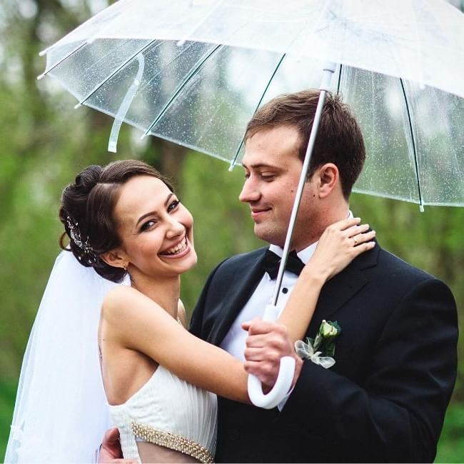 Couple under umbrella featuring our article on 