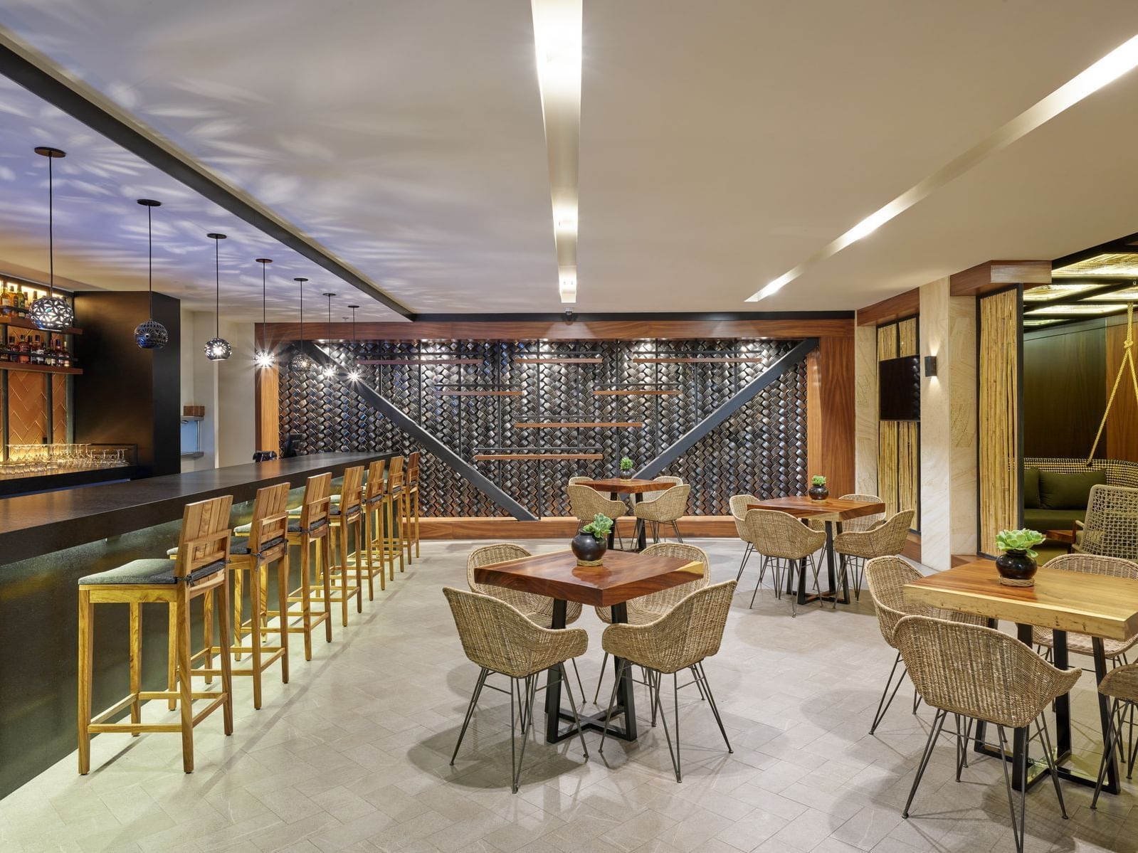 Tables by the counter of Bar Agave Lounge, La Colección Resorts