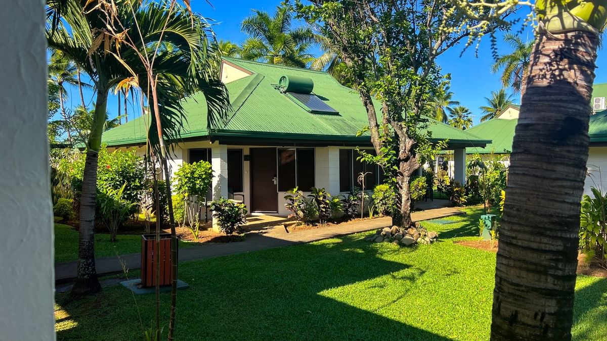 Green villa with lush garden and palm trees at Tokatoka Resort - Fiji International Airport in Nadi.