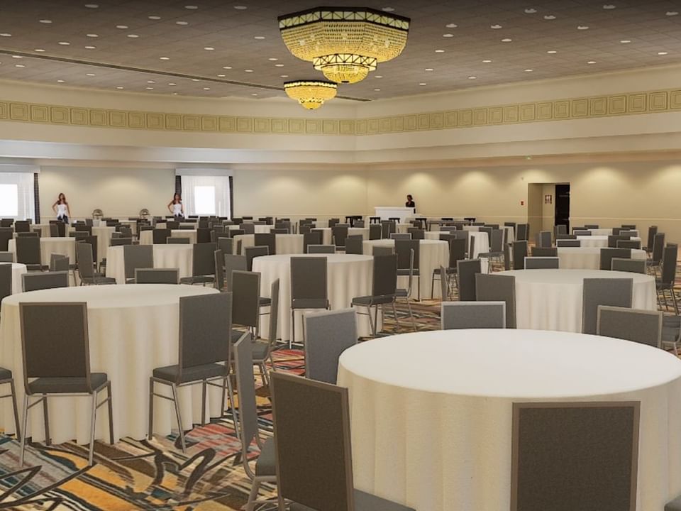 Banquet setup Pablo Casals Ballroom for an event, featuring round tables, chairs, and chandeliers at El Conquistador Resort