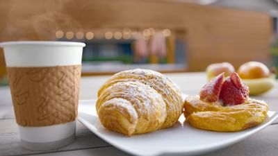A coffee cup & fresh croissants served at The Nest Palo Alto