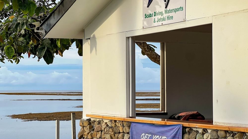 Dive Centre building with ocean view and Get Your PADI banner at The Naviti Resort in Korolevu.