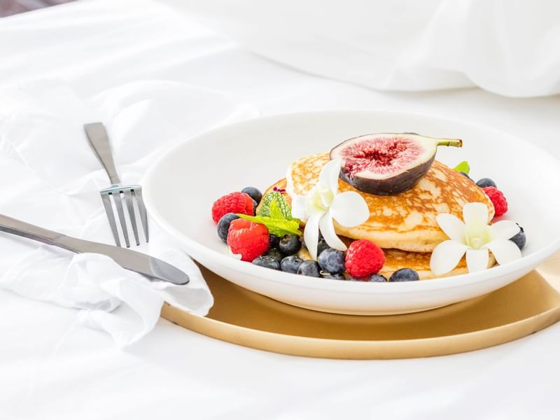Close-up of dish of pancakes with berries at Pullman Cairns