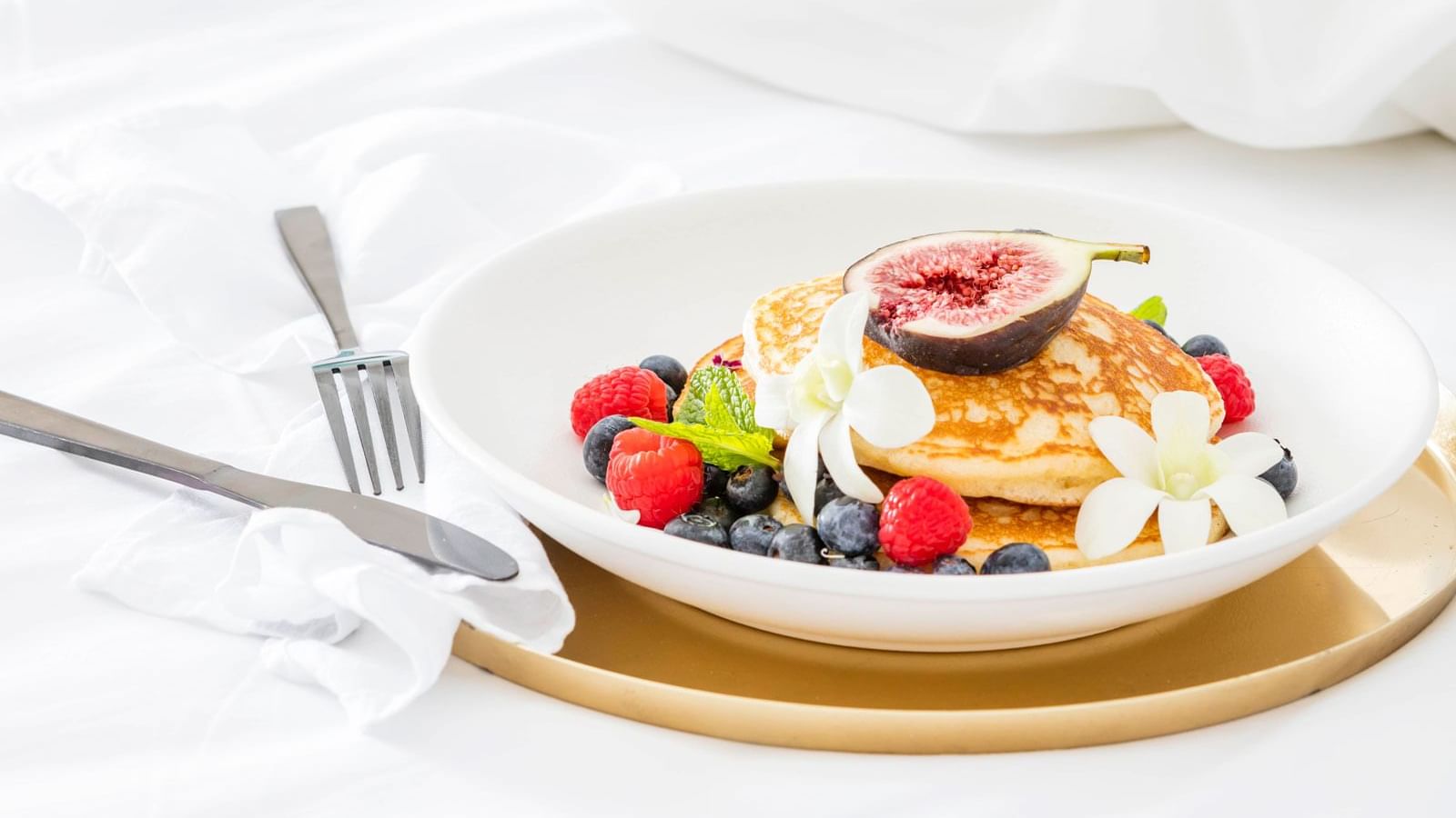 Close-up of dish of pancakes with berries at Pullman Cairns