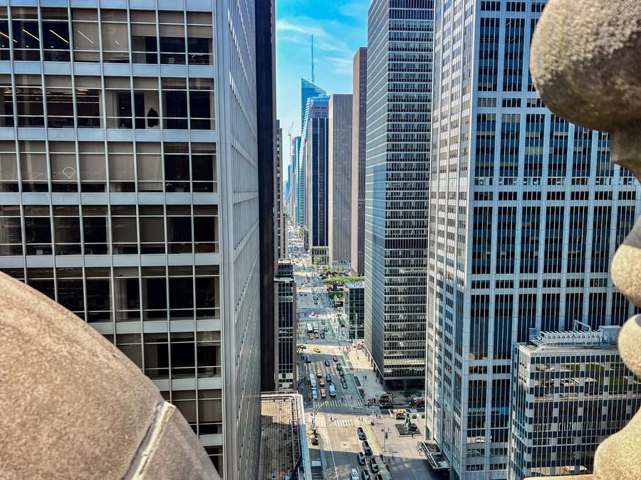Aerial view of a bustling city street with tall buildings and busy traffic.