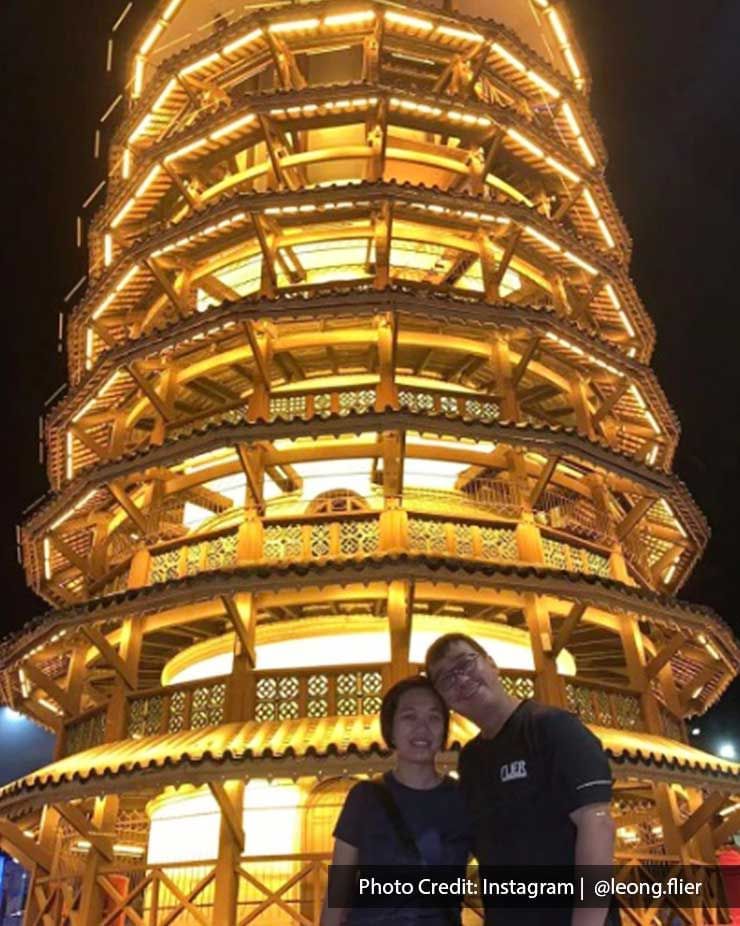 A couple were taking photos with the Teluk Intan Leaning Tower - Lexis Suites Penang