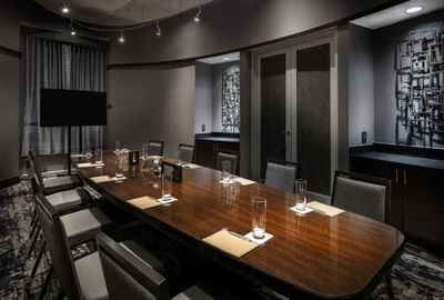 conference room with long table and television at the end