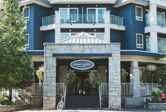 Blue building with entrance named Summit Lodge at Paradox Hotels and Resorts Portal