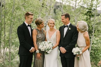 A bride posing with her family & friends at Stein Eriksen Lodge