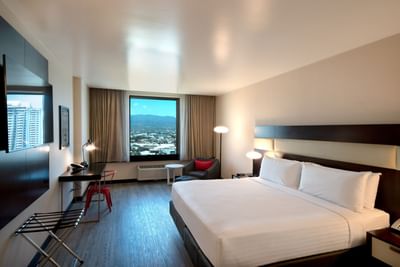 1 King Bed, Panoramic View with bed facing TV, work desk & window with city view at D Sabana Hotel, San Jose Costa Rica Hotel