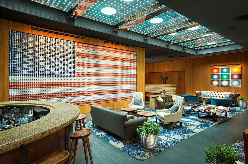 Wall with American flag and lobby & bar at Dream Downtown NYC