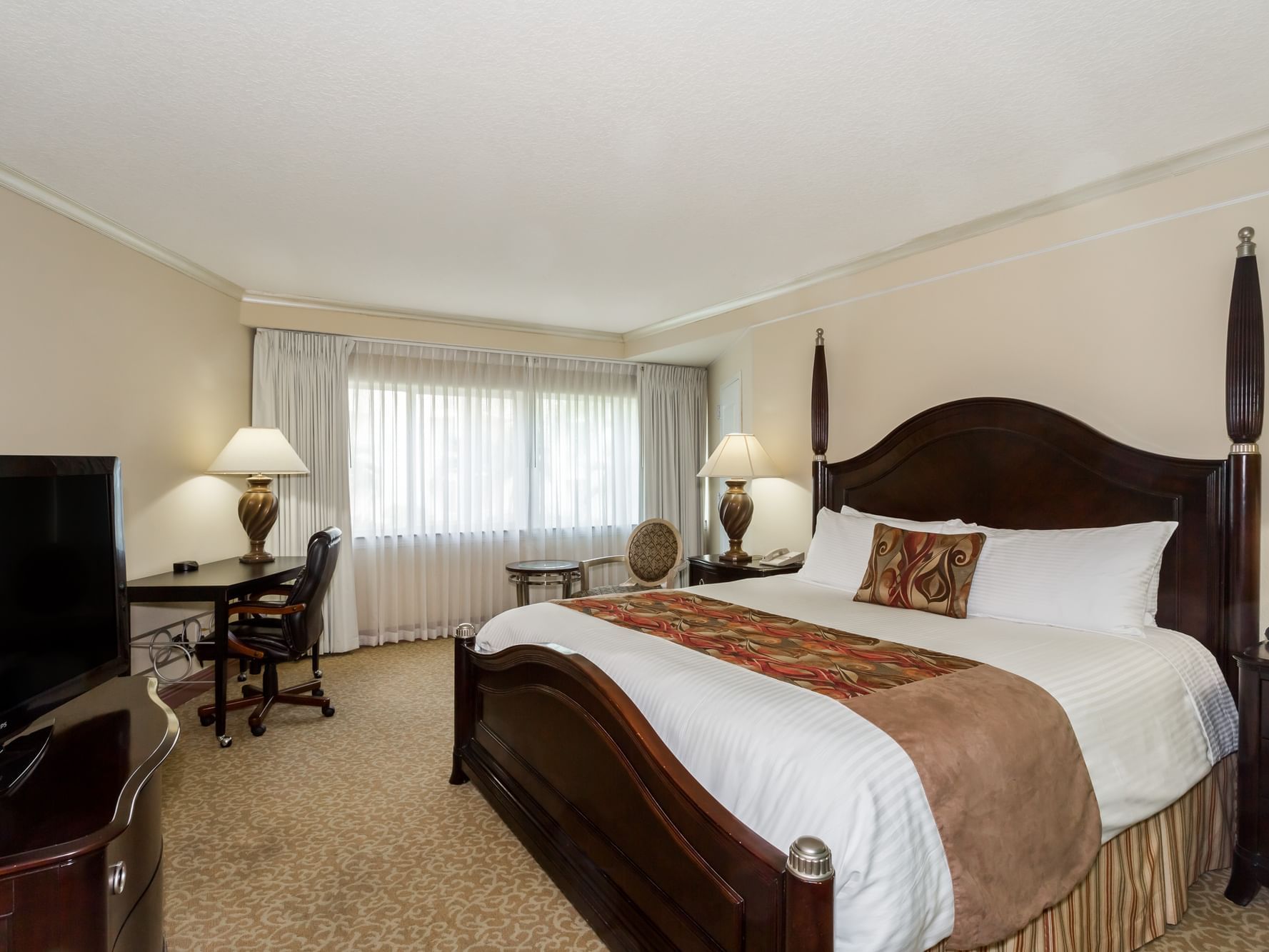 King bed & TV in bedroom at Safety Harbor & Resort