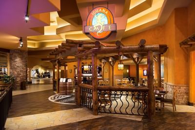 Entrance to Iguana Café at Hilton Santa Fe Buffalo Thunder, featuring warm, inviting wooden decor