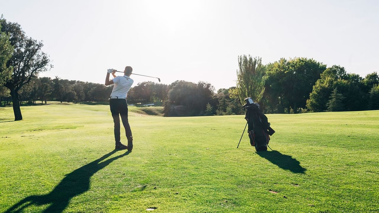 Golfer Captured Mid-Swing with Trusty Bag