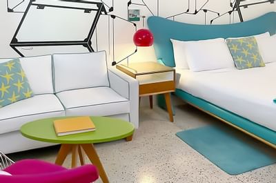 A visual, showing the seating area and the bed