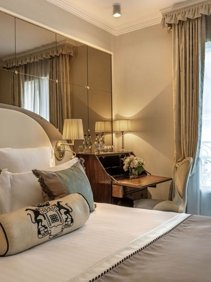 Bed with a working desk by the window in Superior Single Room at Hotel Westminster Paris