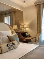 Bed with a working desk by the window in Superior Single Room at Hotel Westminster Paris