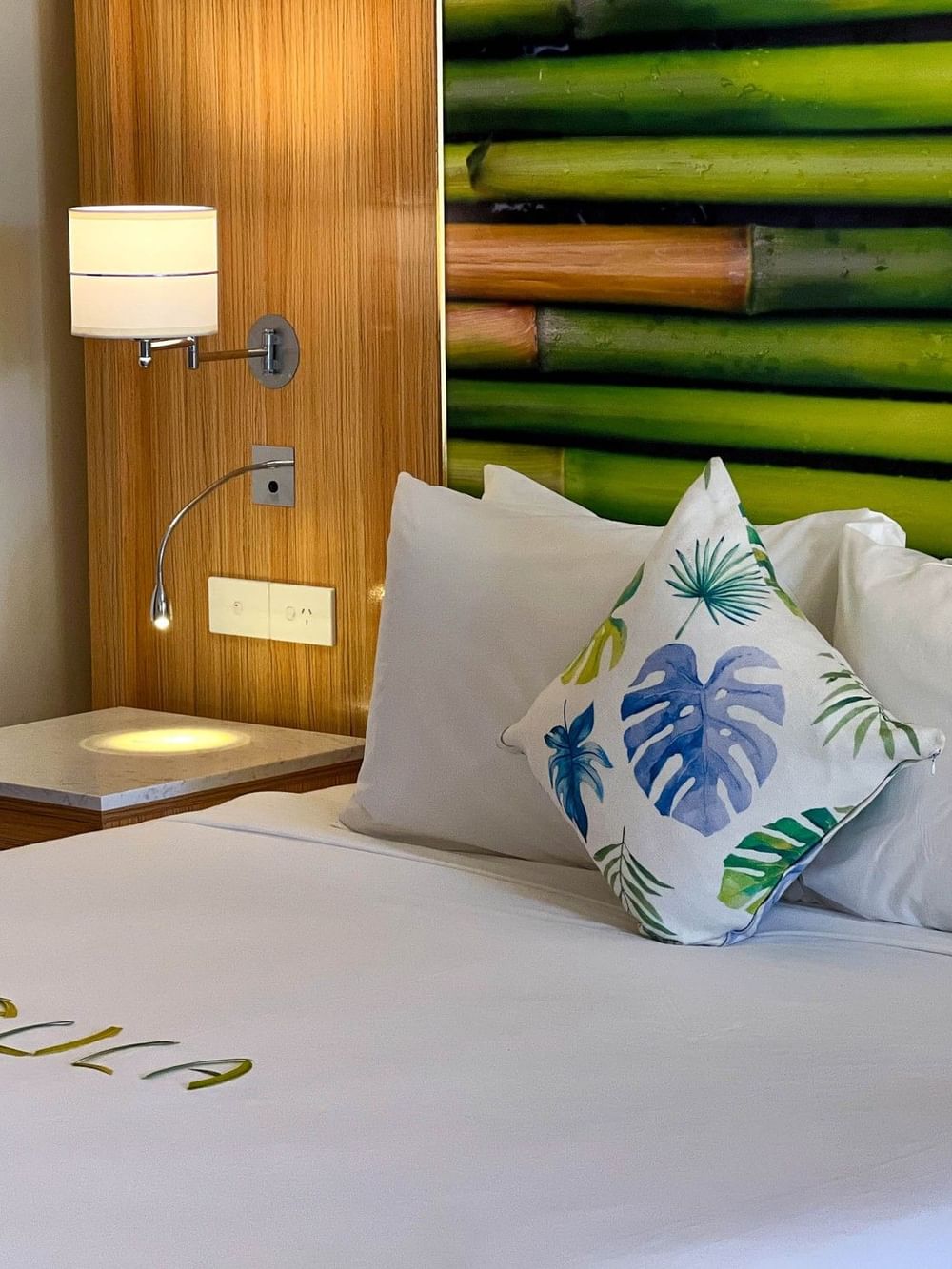 Suite at The Naviti Resort - Fiji in Korolevu with tropical decor and white bedding.