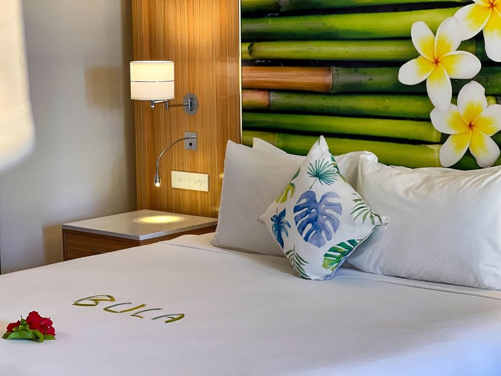 Suite at The Naviti Resort - Fiji in Korolevu with tropical decor and white bedding.
