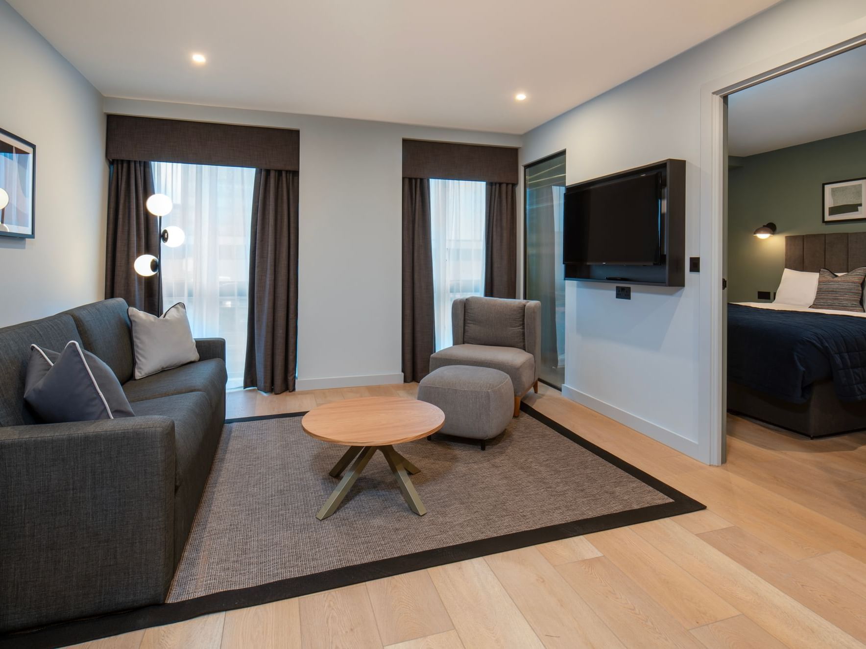  Lounge area with sofas and television with a door leading to the bedroom