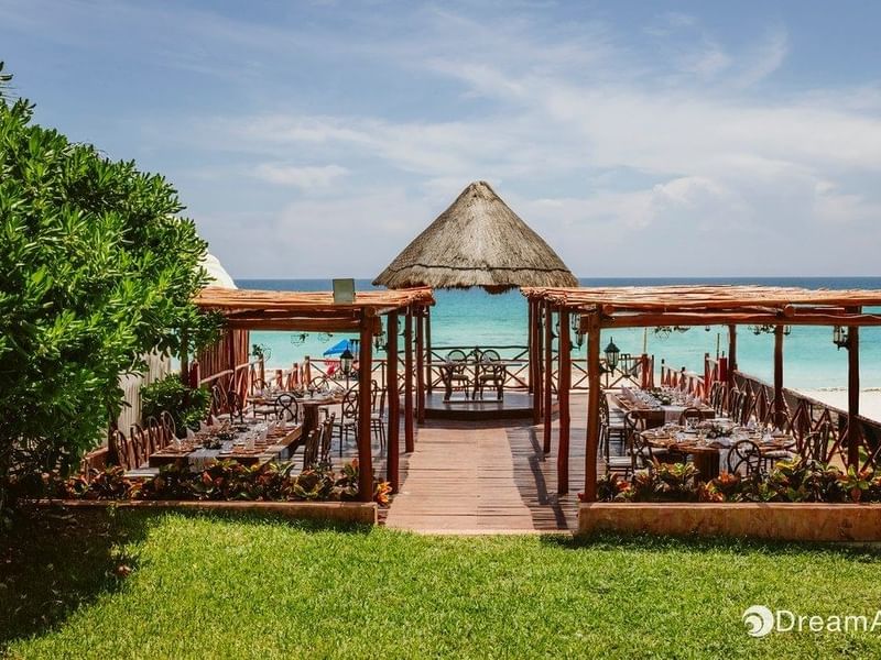 Outdoor dinning area by the beach at Fiesta Americana Cozumel