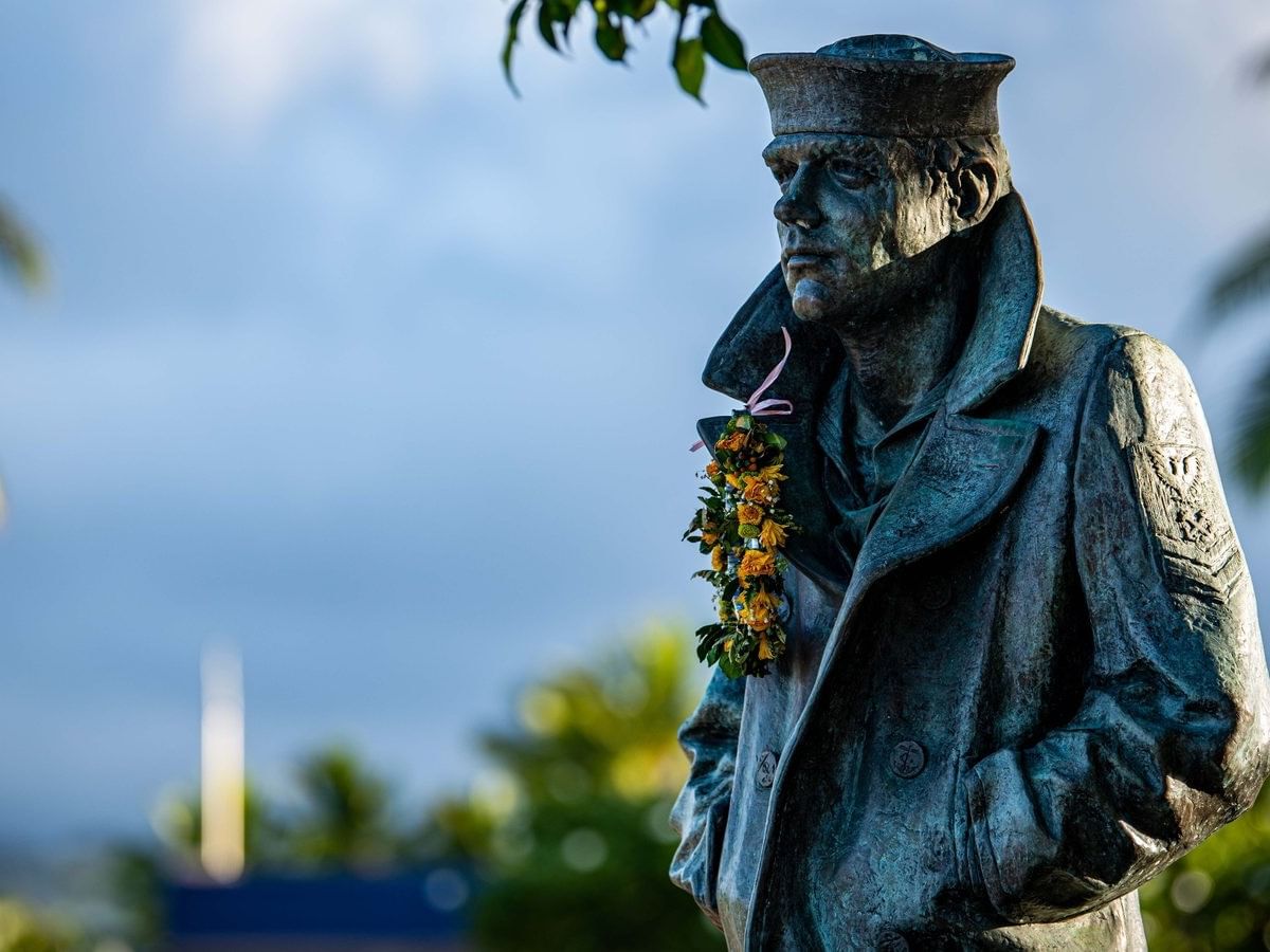 Lone Sailor statue with lei at Pearl Harbor National Memorial