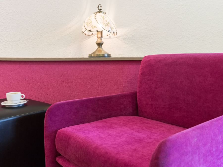 Closeup on pink color sofa chair in a living room at Hotel Arum