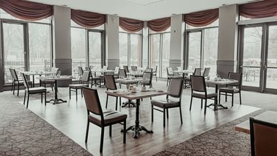 Dining setup in Garden Room with high windows and drapery at Spencer Hotel, one of the best restaurants in London Ontario
