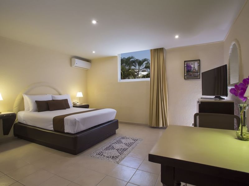 Large bed, TV & desk in the Superior Room at Gamma Hotels