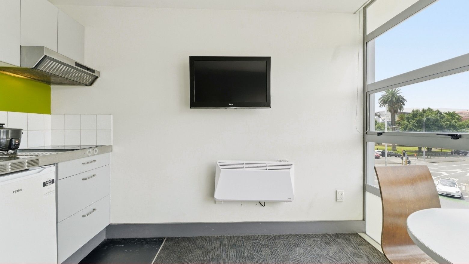 Modern kitchen with TV and heater in a room at Student Living Auckland - Beach.