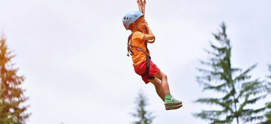 Child ziplining outdoors