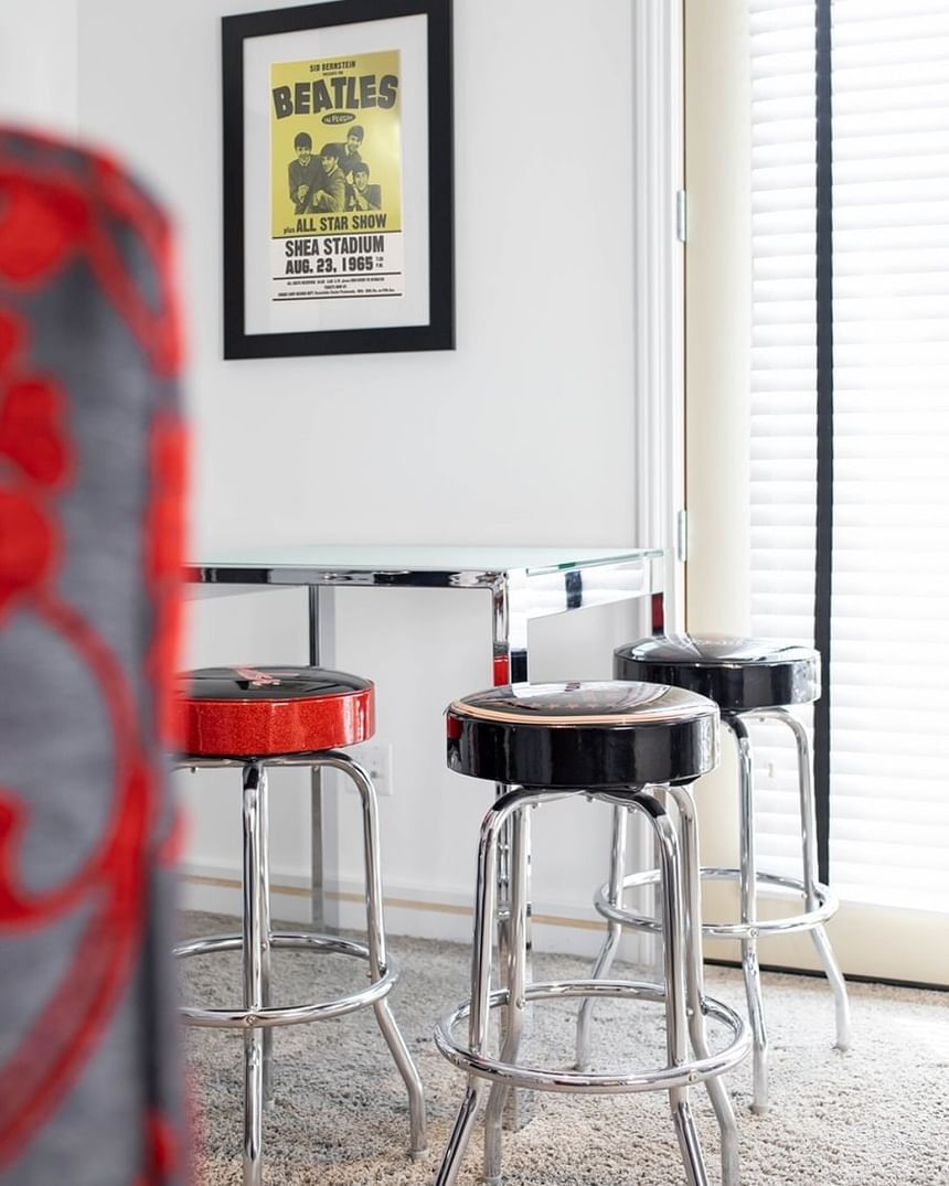 table with 4 stools, rock n roll themed, beatles poster
