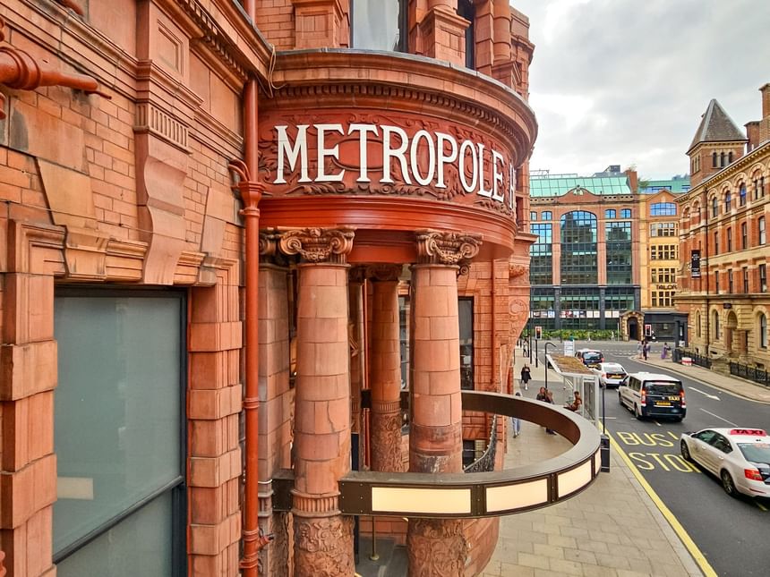 The Met Hotel Leeds entrance with Metropole sign above England Street, showcasing a stunning red brick Victorian design