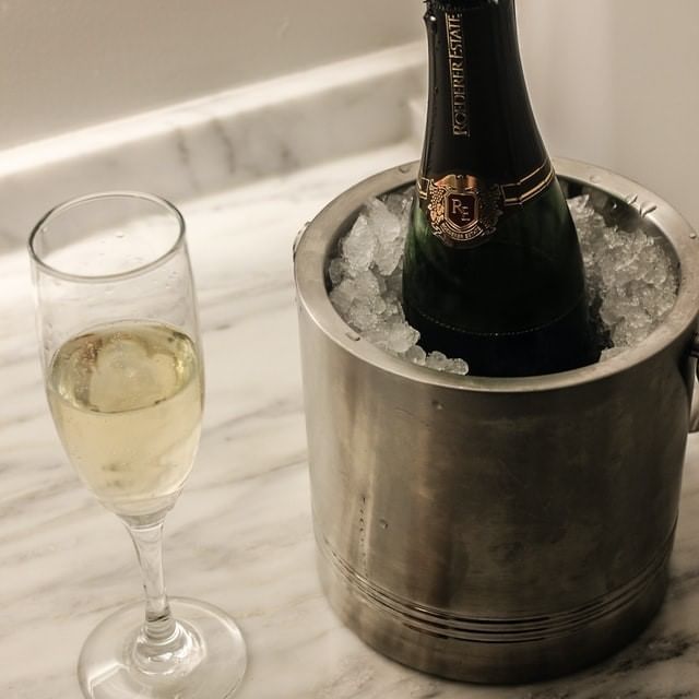 Chilled Champagne bottle & glass served at La Galerie Hotel